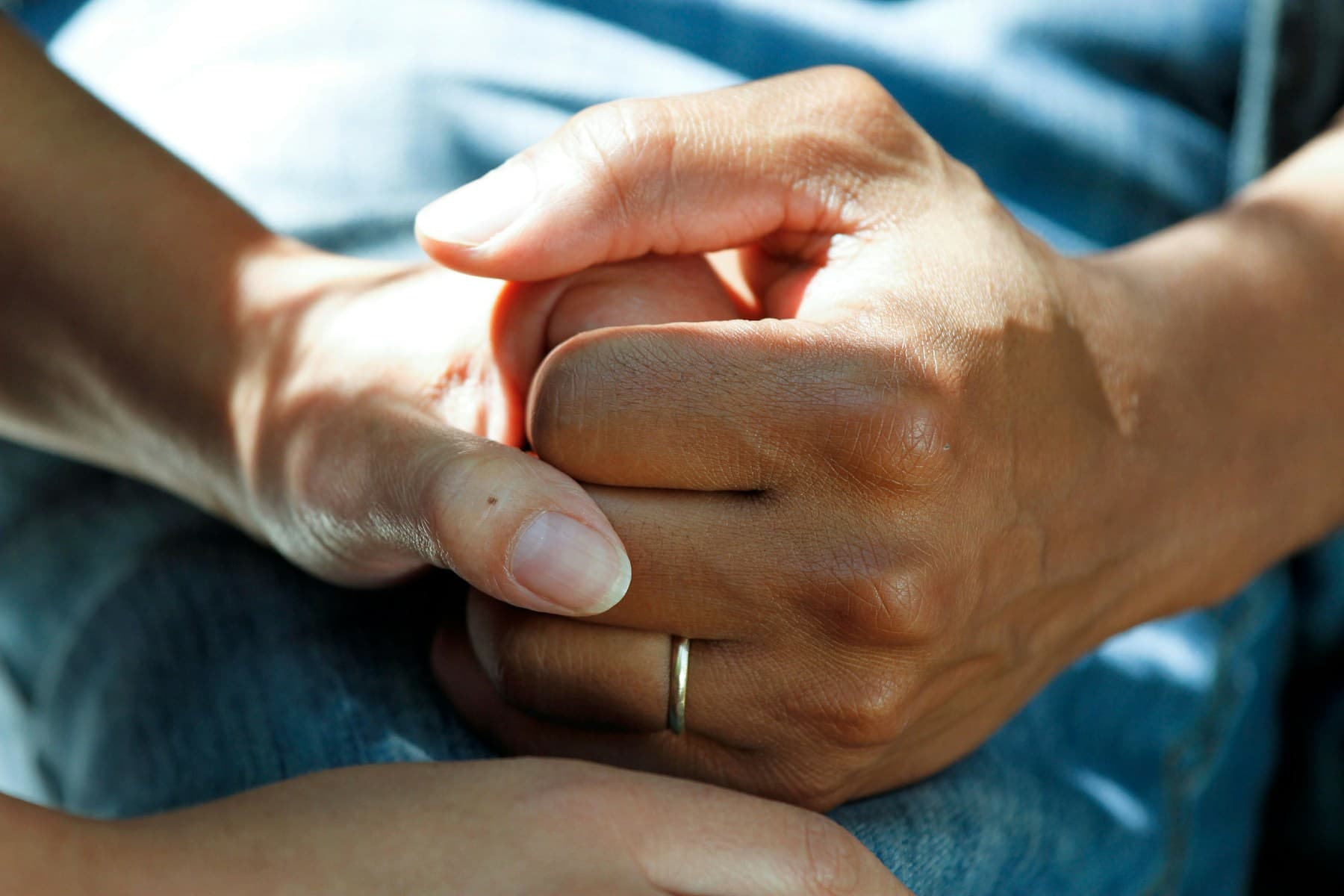 Two people holding hands supportively