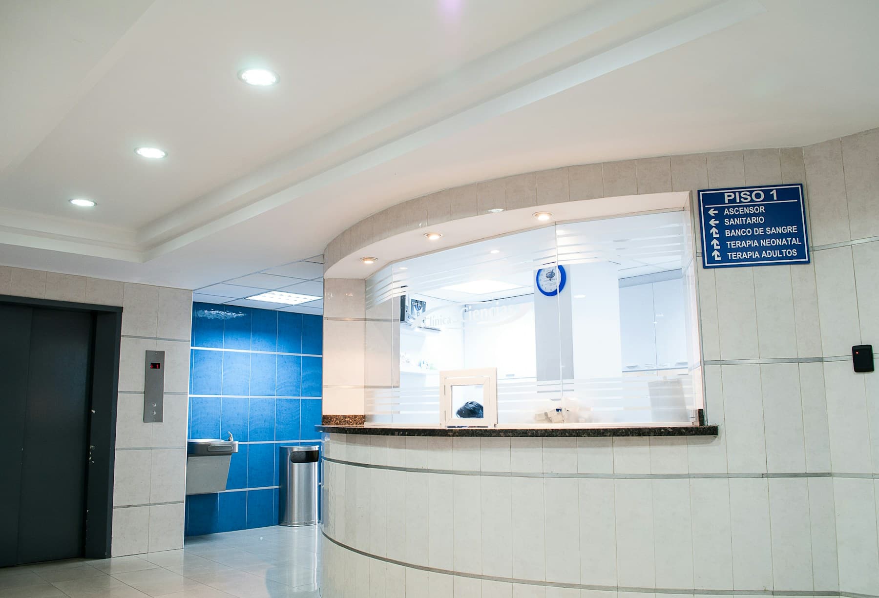 A bright, modern clinic interior with seating and a reception desk